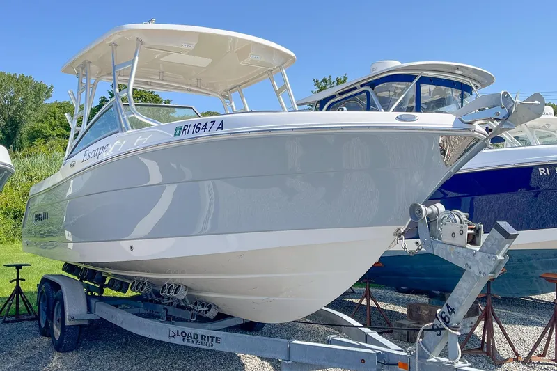The Image of 2019 Robalo R247 Dual Console boat on trailer, parked outdoors. - 1