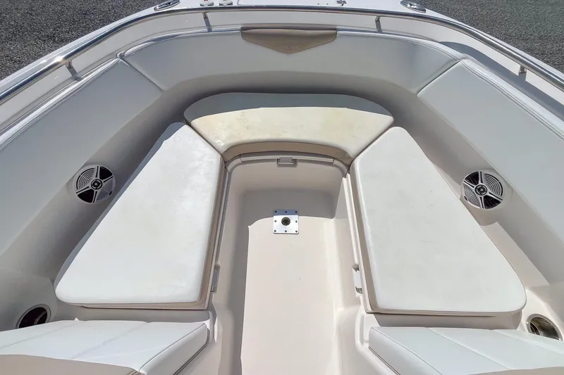 Slide: The Image of 2019 Robalo R247 Dual Console boat interior with cushioned seating and speakers. - 12