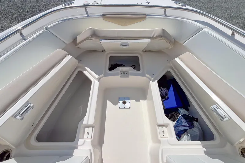 Slide: The Image of 2019 Robalo R247 Dual Console boat interior with spacious seating and storage compartments. - 13