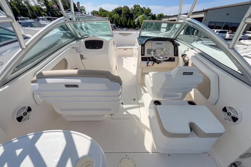 Slide: The Image of 2019 Robalo R247 Dual Console boat interior with helm, seating, and modern controls. - 8