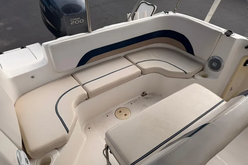 Slide: The Image of 2006 Hurricane FunDeck GS 211 OB boat interior with cushioned seating and Yamaha 200 outboard motor. - 23
