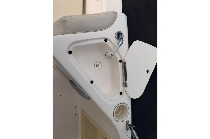 Slide: The Image of 2006 Hurricane FunDeck GS 211 OB boat interior detail with cup holder and faucet. - 26