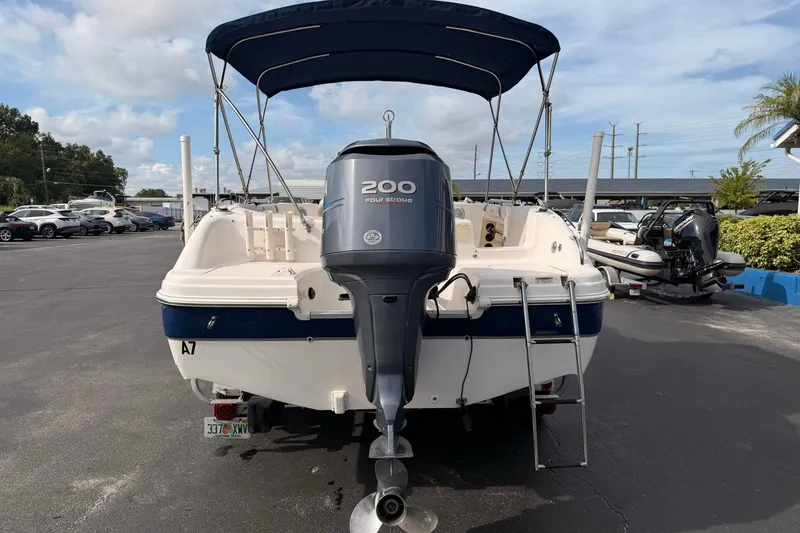 Slide: The Image of 2006 Hurricane FunDeck GS 211 OB boat with 200 horsepower engine, parked outdoors. - 9