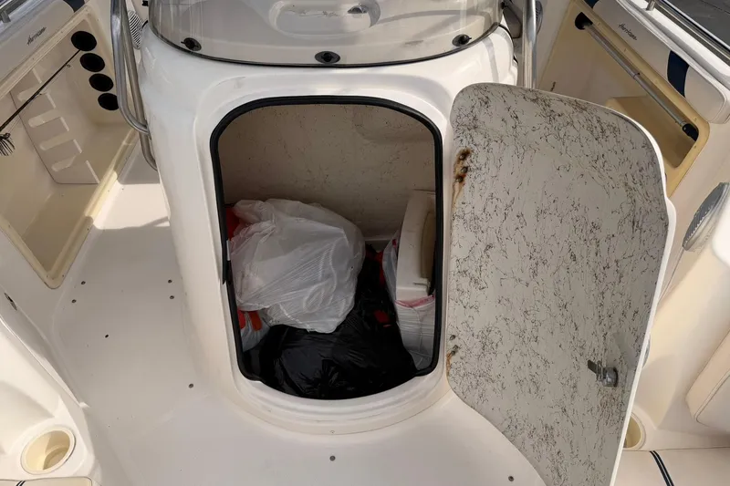 Slide: The Image of Open storage compartment on a 2006 Hurricane FunDeck GS 211 OB boat. - 16
