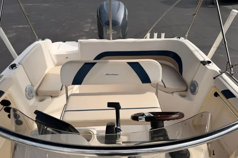 Slide: The Image of 2006 Hurricane FunDeck GS 211 OB boat interior with seating and steering wheel. - 17