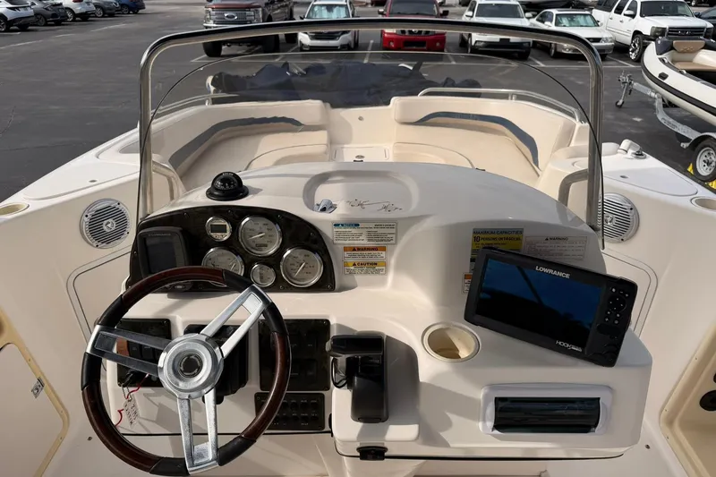 Slide: The Image of 2006 Hurricane FunDeck GS 211 OB boat dashboard with steering wheel and navigation system. - 11