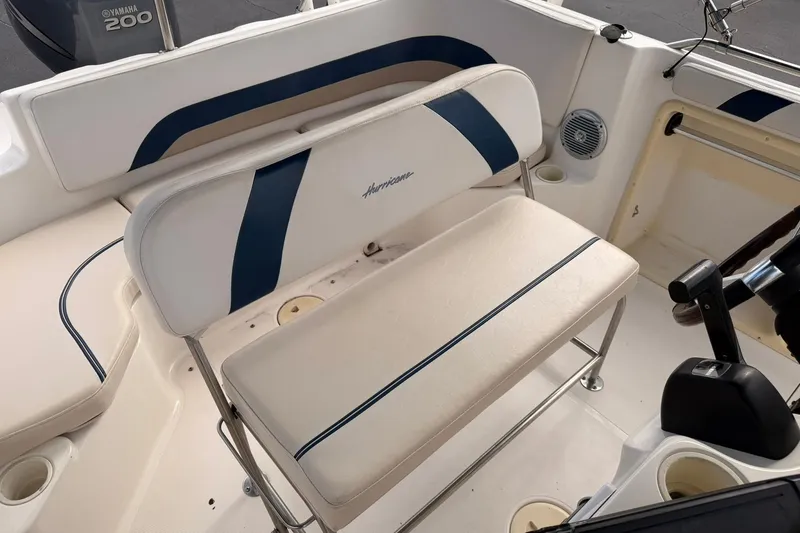 Slide: The Image of 2006 Hurricane FunDeck GS 211 OB boat interior with seating and Yamaha 200 engine. - 24