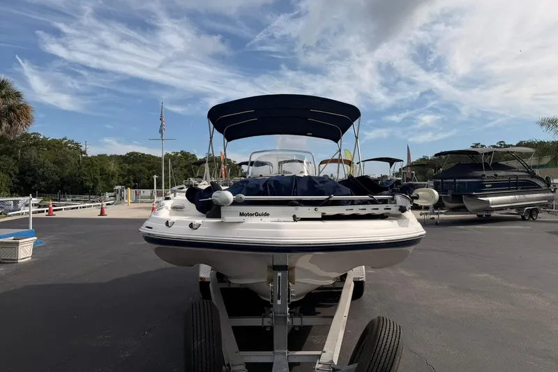Slide: The Image of 2006 Hurricane FunDeck GS 211 OB boat on trailer under blue sky. - 3