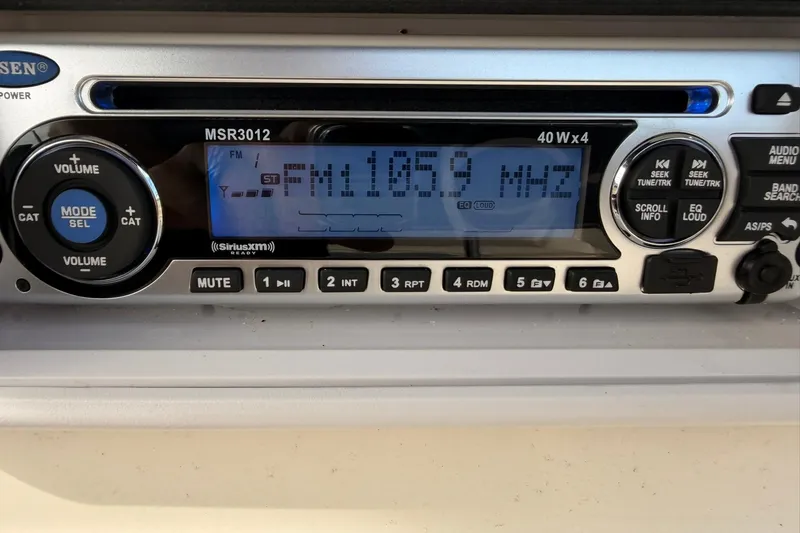 Slide: The Image of Boat stereo system displaying FM 105.9 MHz, Hurricane FunDeck GS 211 OB, 2006 model. - 22