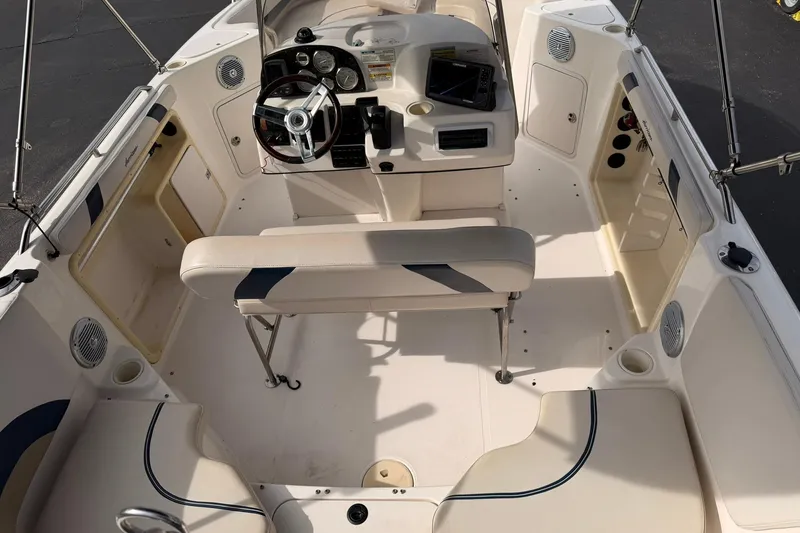 Slide: The Image of 2006 Hurricane FunDeck GS 211 OB boat interior with steering wheel and seating. - 10