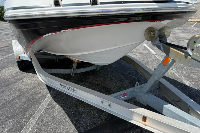 Slide: The Image of 2014 Hurricane SunDeck Sport 188 OB boat on a Phoenix trailer in a parking lot. - 22