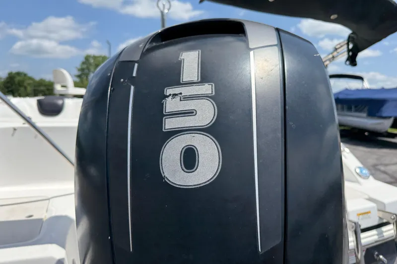 Slide: The Image of Outboard motor on a 2014 Hurricane SunDeck Sport 188 OB boat, featuring a 150 horsepower engine. - 9