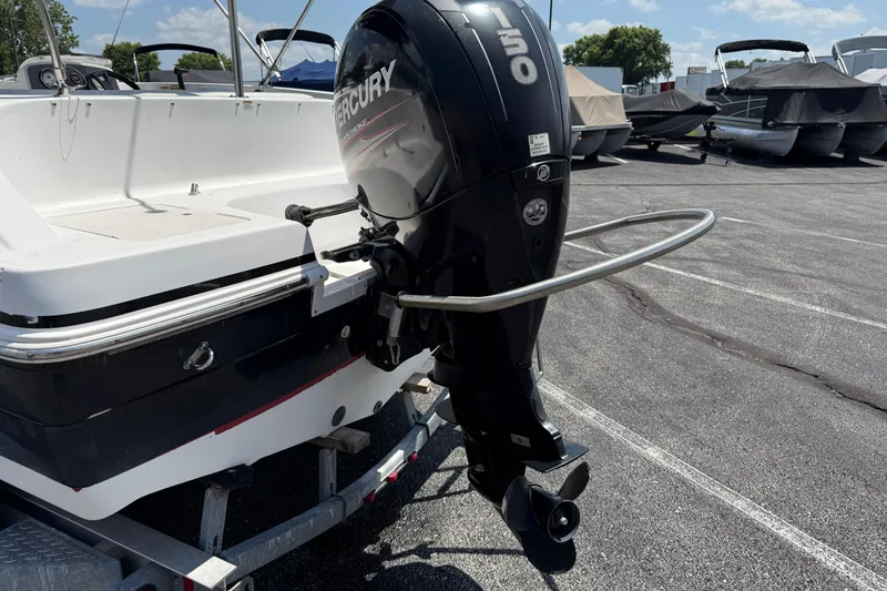 Slide: The Image of 2014 Hurricane SunDeck Sport 188 OB with Mercury outboard motor in a parking lot. - 29
