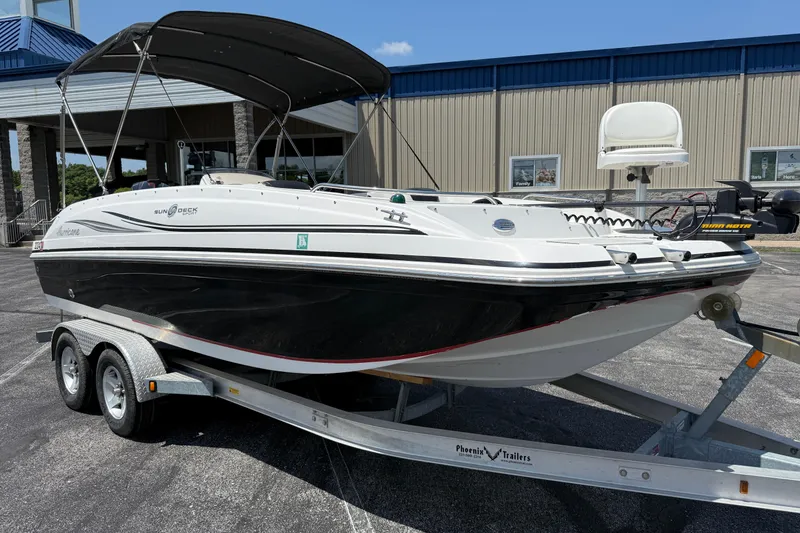 Slide: The Image of 2014 Hurricane SunDeck Sport 188 OB boat on trailer, parked outdoors. - 4