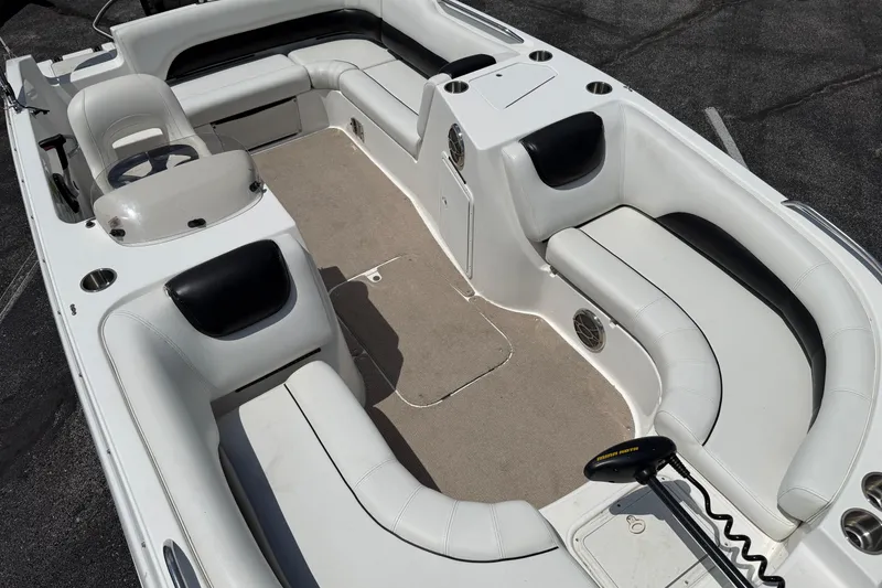 Slide: The Image of 2014 Hurricane SunDeck Sport 188 OB boat interior with white seating and steering console. - 15