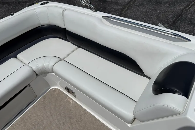 Slide: The Image of 2014 Hurricane SunDeck Sport 188 OB boat interior with white and black cushioned seating. - 18