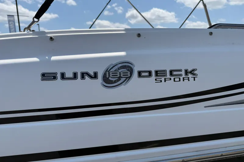 Slide: The Image of 2014 Hurricane SunDeck Sport 188 OB boat logo with blue sky background. - 27
