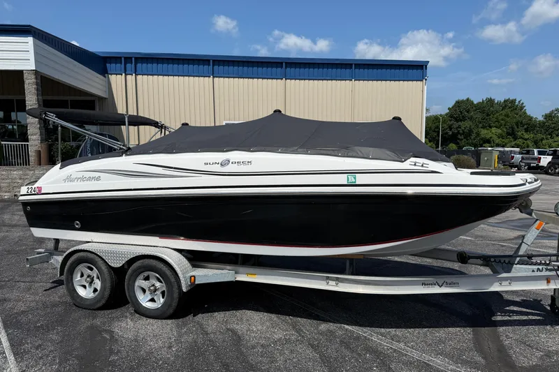 Slide: The Image of 2014 Hurricane SunDeck Sport 188 OB boat on trailer, parked outdoors. - 5