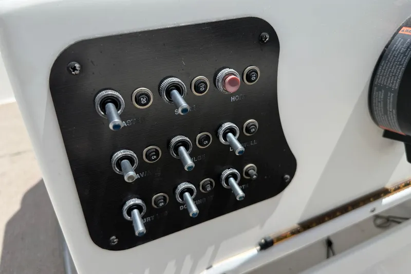 Slide: The Image of Control panel of a 2014 Hurricane SunDeck Sport 188 OB boat with toggle switches. - 21