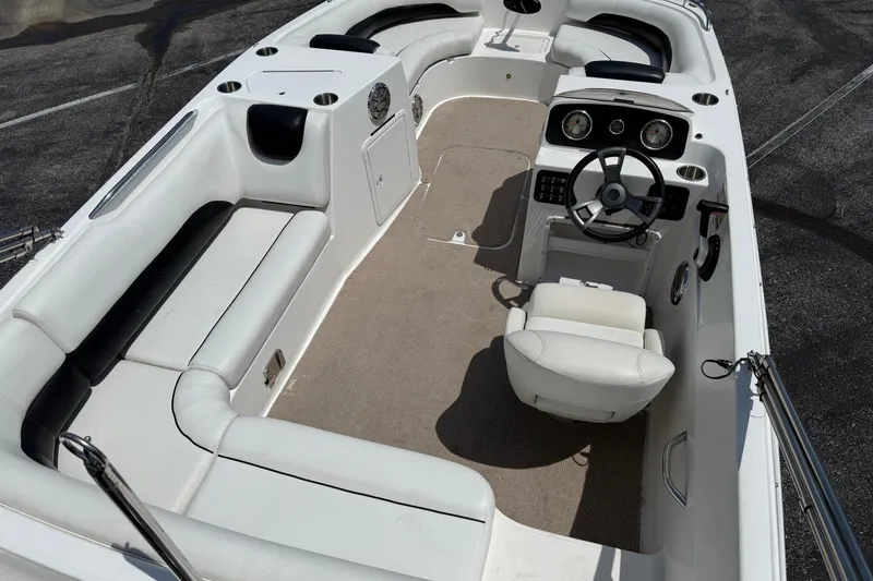 Slide: The Image of 2014 Hurricane SunDeck Sport 188 OB boat interior with white seating and steering console. - 10