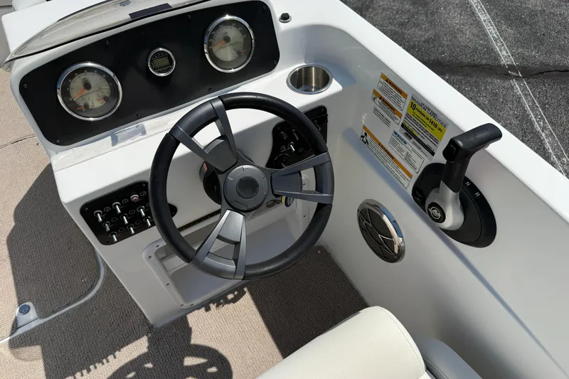 Slide: The Image of 2014 Hurricane SunDeck Sport 188 OB boat dashboard with steering wheel and controls. - 8