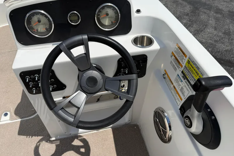 Slide: The Image of 2014 Hurricane SunDeck Sport 188 OB boat dashboard with steering wheel and controls. - 11