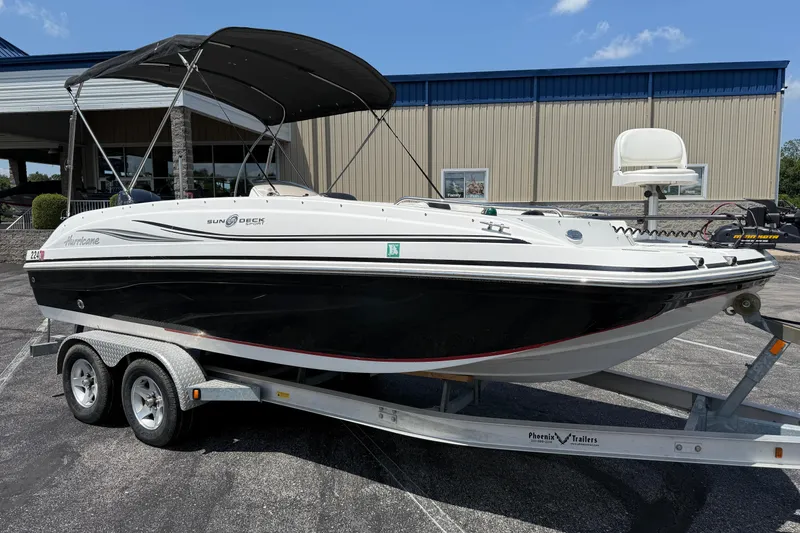 Slide: The Image of 2014 Hurricane SunDeck Sport 188 OB boat on trailer, parked outdoors. - 3