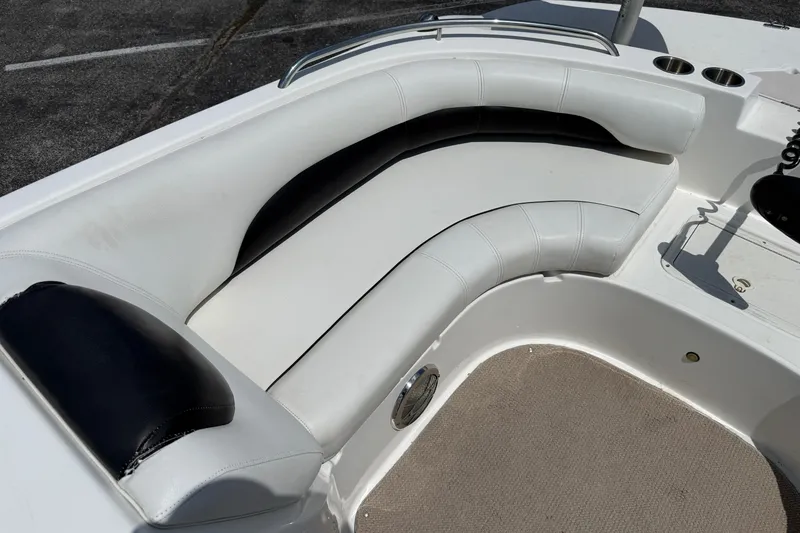 Slide: The Image of 2014 Hurricane SunDeck Sport 188 OB boat interior with white and black cushioned seating. - 14