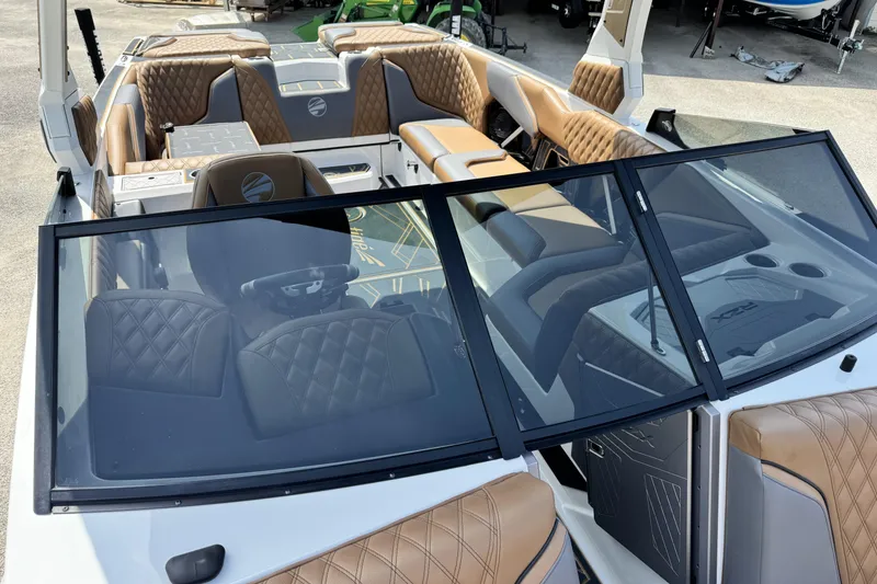 Slide: The Image of 2025 Tigé 24RZX boat interior with luxurious brown leather seating and modern dashboard. - 20