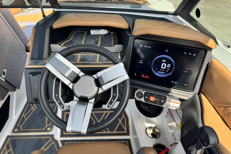 Slide: The Image of 2025 Tigé 24RZX boat dashboard with modern steering wheel and touchscreen display. - 13