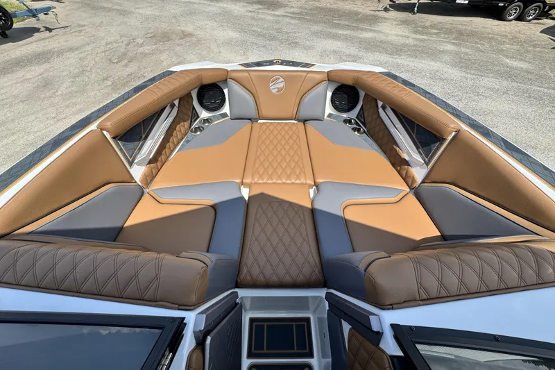 Slide: The Image of 2025 Tigé 24RZX boat interior with luxurious tan and gray seating, featuring diamond stitching. - 15