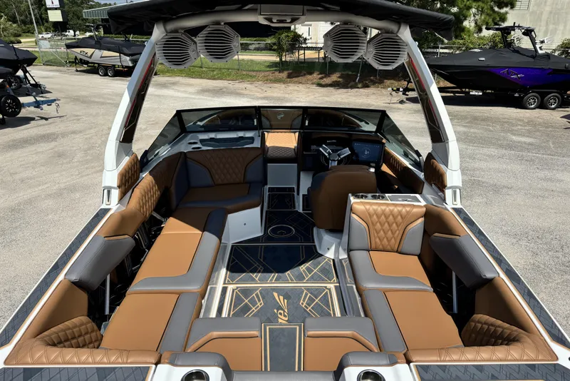 Slide: The Image of 2025 Tigé 24RZX boat interior with luxurious brown and gray seating, advanced dashboard. - 11