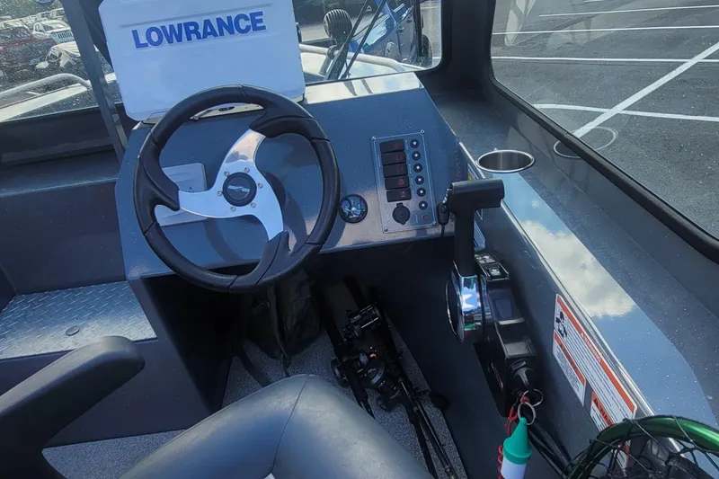 Slide: The Image of 2023 Fish Rite 210 Performer boat dashboard with steering wheel and control panel. - 6