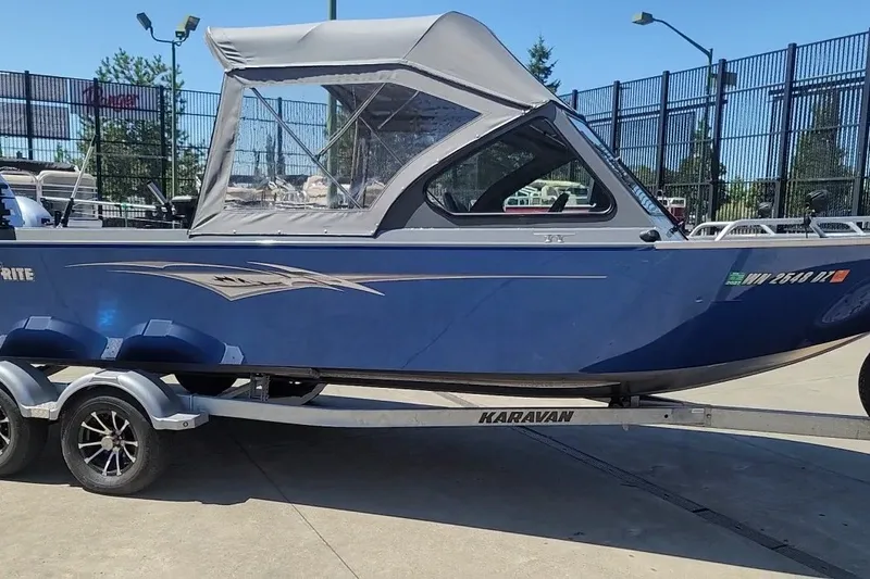 The Image of 2023 Fish Rite 210 Performer boat on Karavan trailer, parked outdoors. - 0