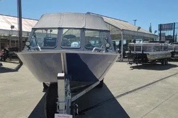 Slide: The Image of A 2023 Fish Rite 210 Performer boat on a trailer in an outdoor area. - 2