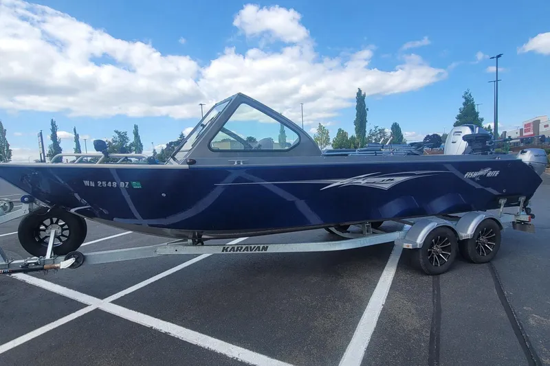 Slide: The Image of 2023 Fish Rite 210 Performer boat on Karavan trailer in parking lot. - 3