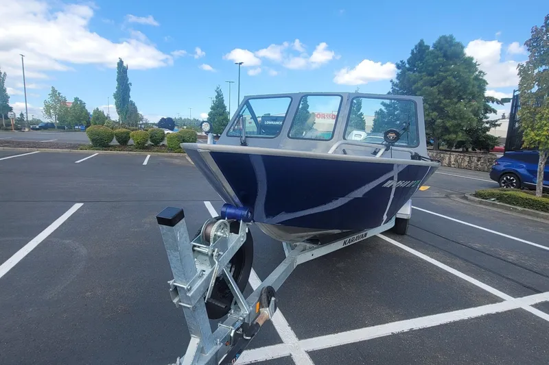 Slide: The Image of 2023 Fish Rite 210 Performer boat on trailer in parking lot. - 4