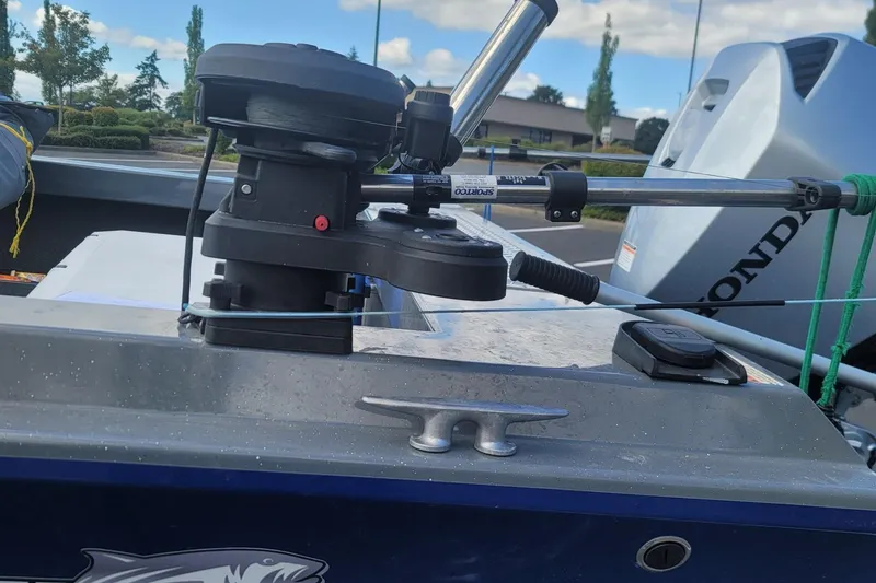 Slide: The Image of 2023 Fish Rite 210 Performer boat with mounted fishing equipment and Honda motor. - 9