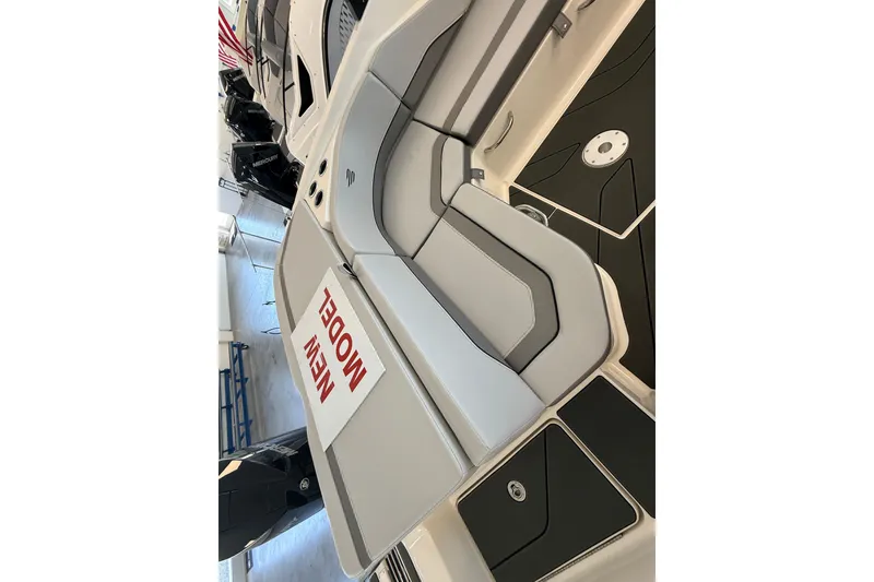 Slide: The Image of 2026 Bayliner V22 boat interior with modern seating and "New Model" sign. - 9