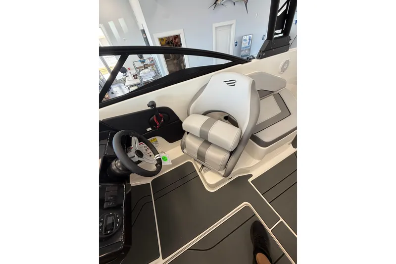 Slide: The Image of Interior of 2026 Bayliner V22 boat, featuring sleek steering and comfortable seating. - 5