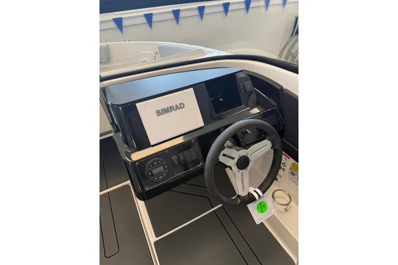 Slide: The Image of 2026 Bayliner V22 dashboard with Simrad navigation system and steering wheel. - 4