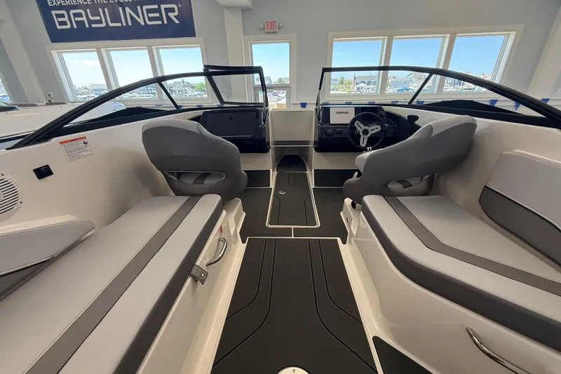 Slide: The Image of Interior view of 2026 Bayliner V22 boat, featuring modern seating and dashboard design. - 3