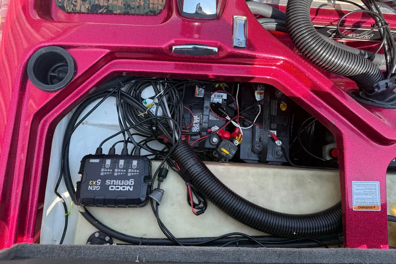 Slide: The Image of 2020 Bass Cat Pantera Classic boat battery compartment with NOCO Genius charger and wiring. - 44