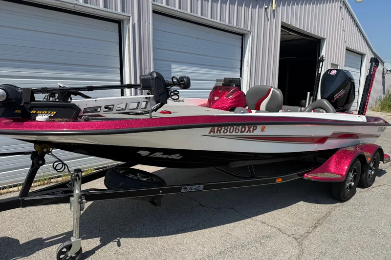 Slide: The Image of 2020 Bass Cat Pantera Classic boat with trailer, parked outside a garage. - 20
