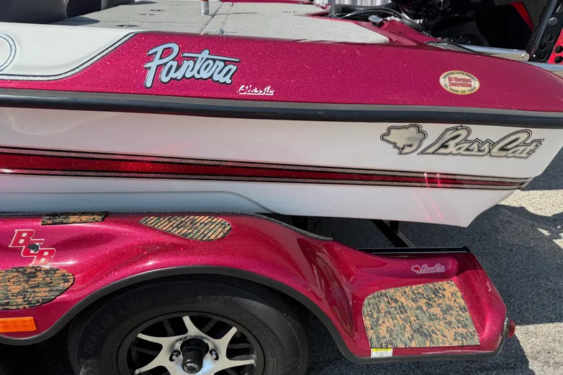 Slide: The Image of 2020 Bass Cat Pantera Classic boat with red and white detailing on a trailer. - 14