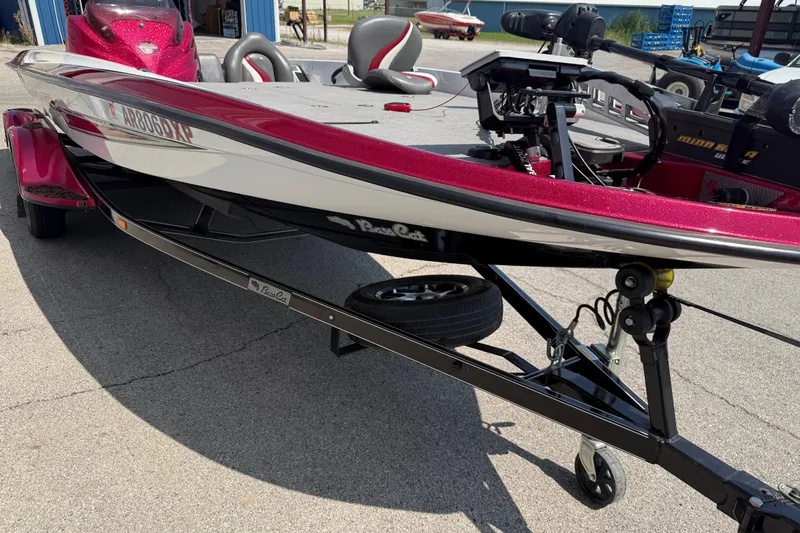 Slide: The Image of 2020 Bass Cat Pantera Classic boat on trailer, red and white design, parked outdoors. - 23