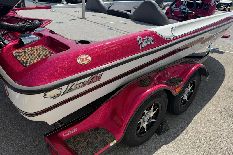 Slide: The Image of 2020 Bass Cat Pantera Classic boat with red and white detailing on a trailer. - 25