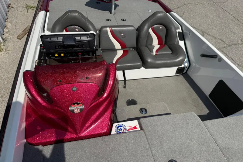 Slide: The Image of 2020 Bass Cat Pantera Classic boat interior with red glitter dashboard and dual seats. - 31