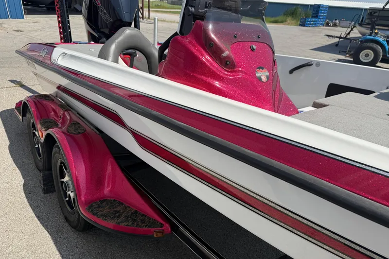 Slide: The Image of 2020 Bass Cat Pantera Classic boat with vibrant red and white detailing, parked outdoors. - 24
