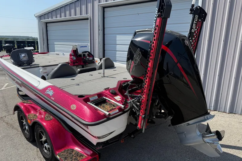 Slide: The Image of 2020 Bass Cat Pantera Classic boat with powerful outboard motor, parked near storage units. - 15